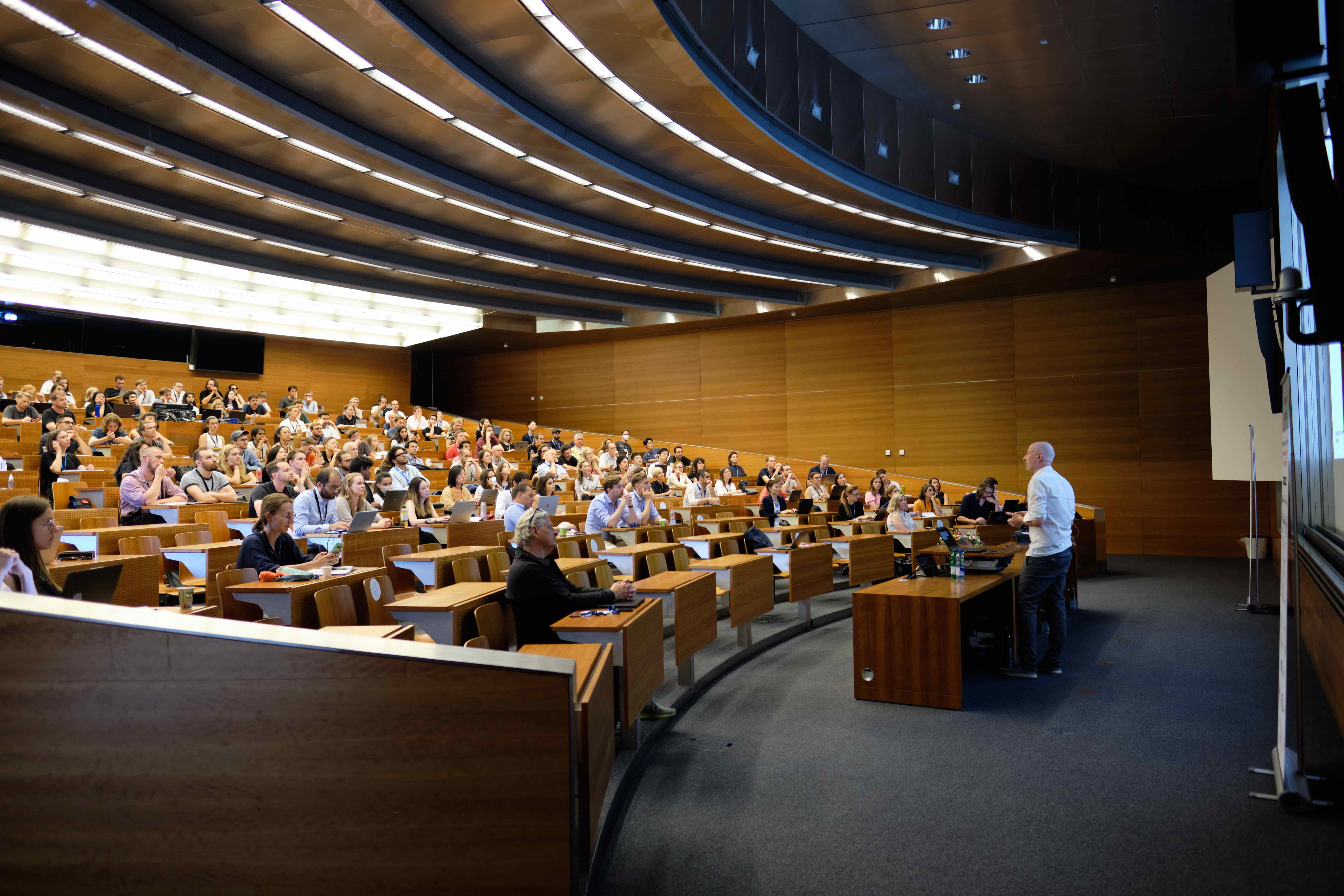 A speaker giving a talk in a lecture Hall.